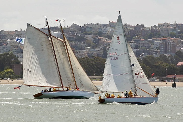 Two Sailboats Race Near Beach